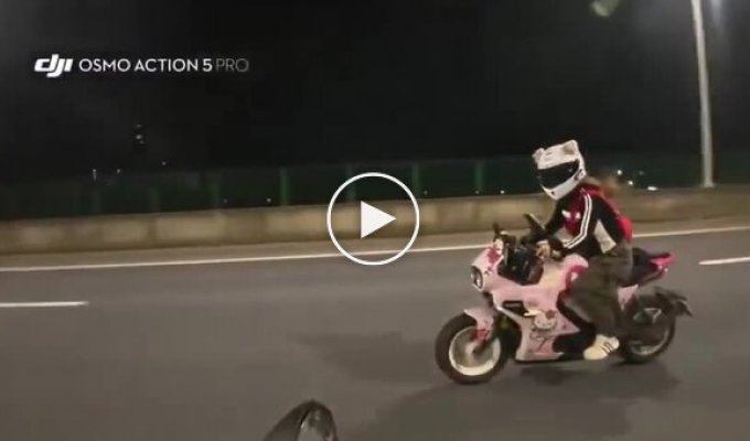 Distracted by a young woman on a pink motorcycle
