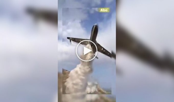 Be-200 flies right over people while dropping water on a fire in Algeria