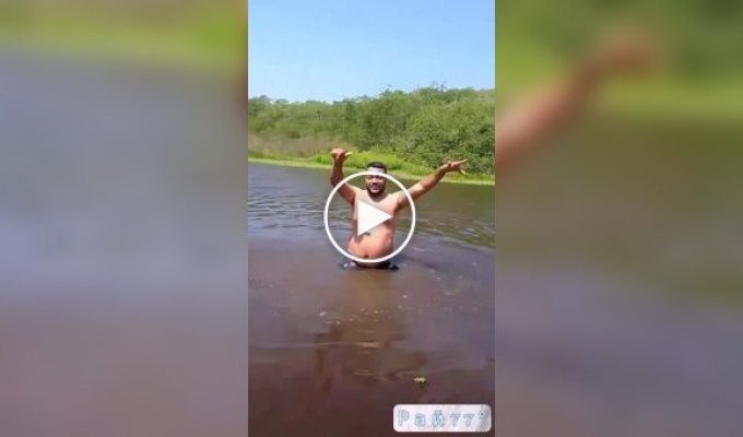 An extreme sportsman swimming in a river attracted the attention of a crocodile