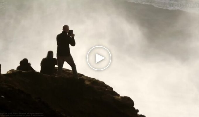 A man managed to save a surfer seconds before a massive wave hit
