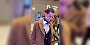 People's reaction at the airport to a tall stewardess